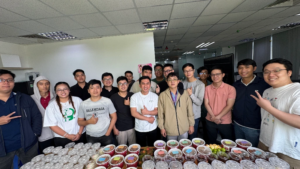 Office team posing behind a large food display